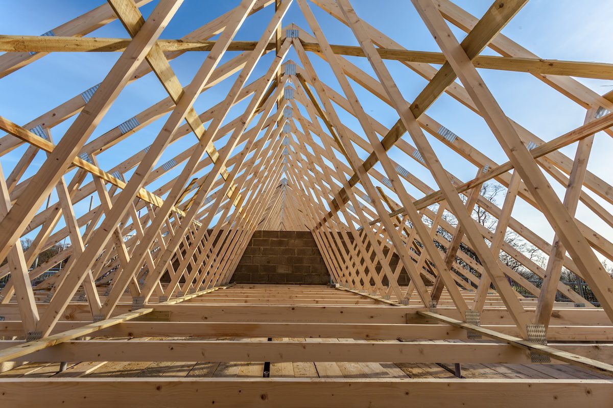 Wood house truss against blue sky