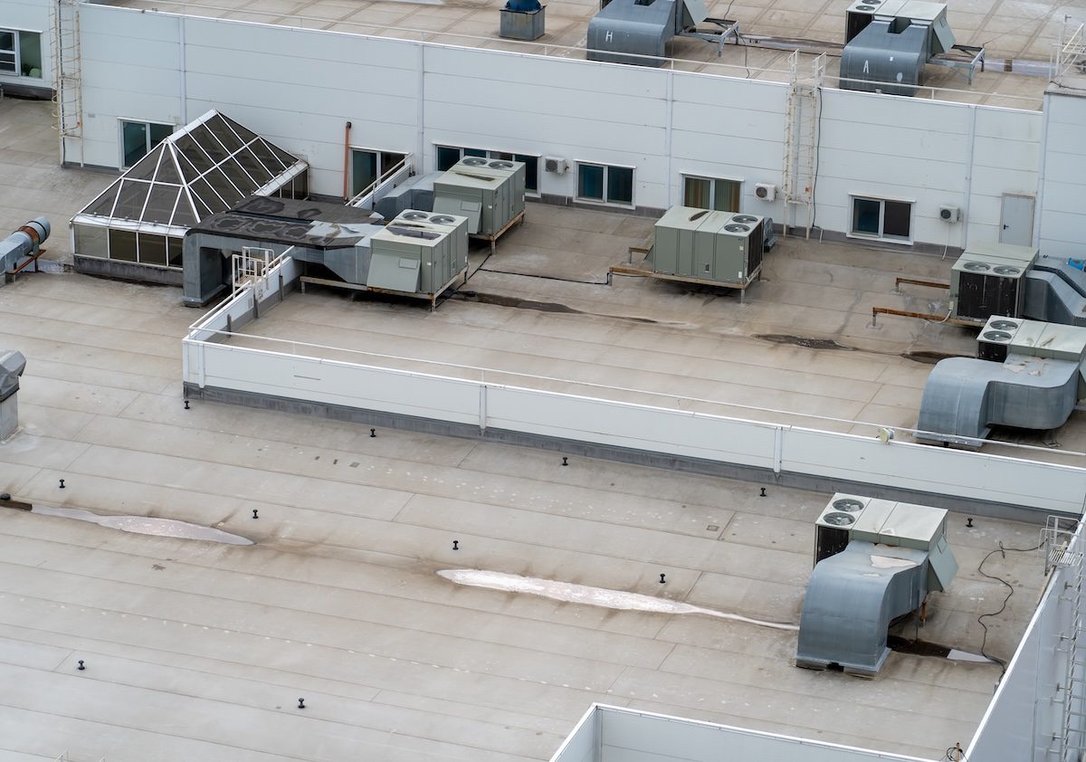 Exhaust vents of industrial air conditioning and ventilation units. Air conditioning system on roof of store or mall building