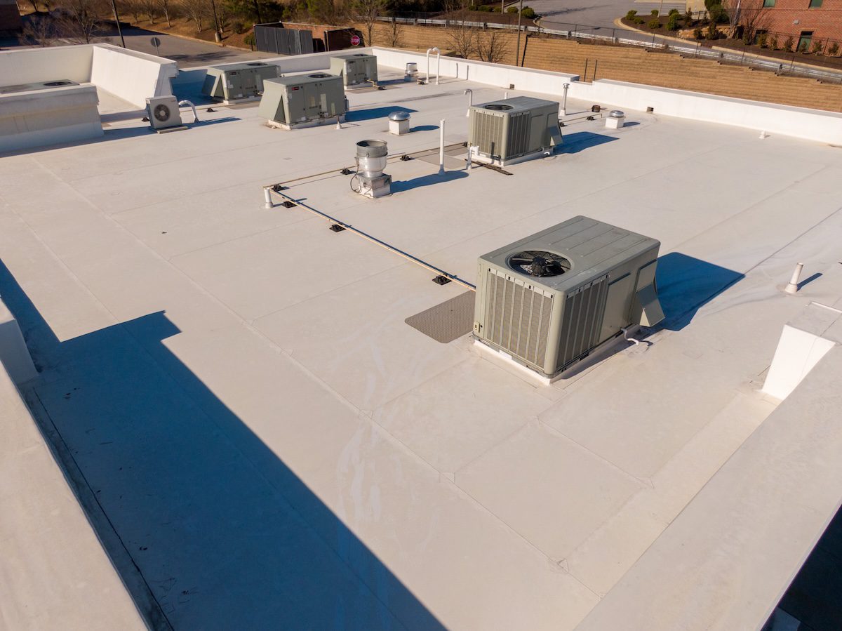 Sunny Day Time Drone Images of a TPO Roof on a Commercial Building.
