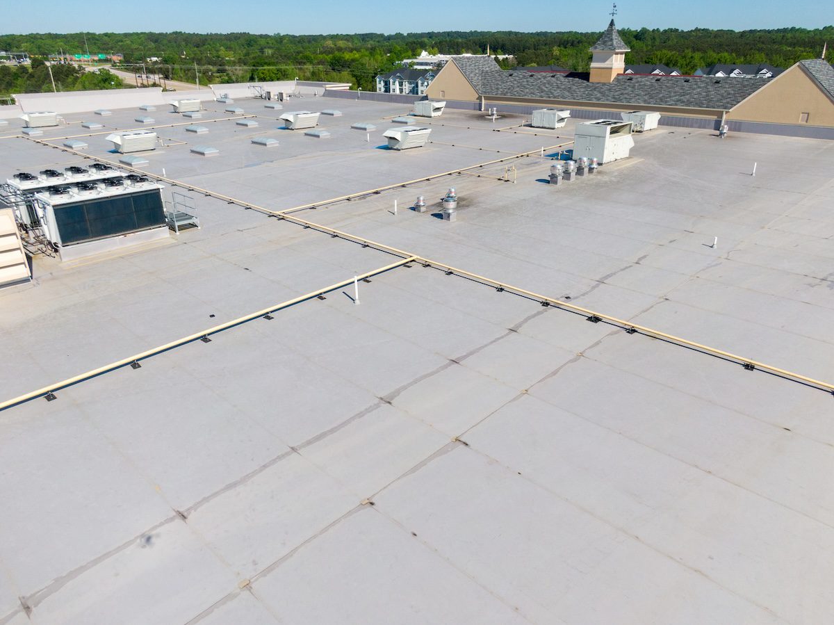 Drone Images of TPO Flat Commercial Roof With Metal Panels: New & Existing Construction