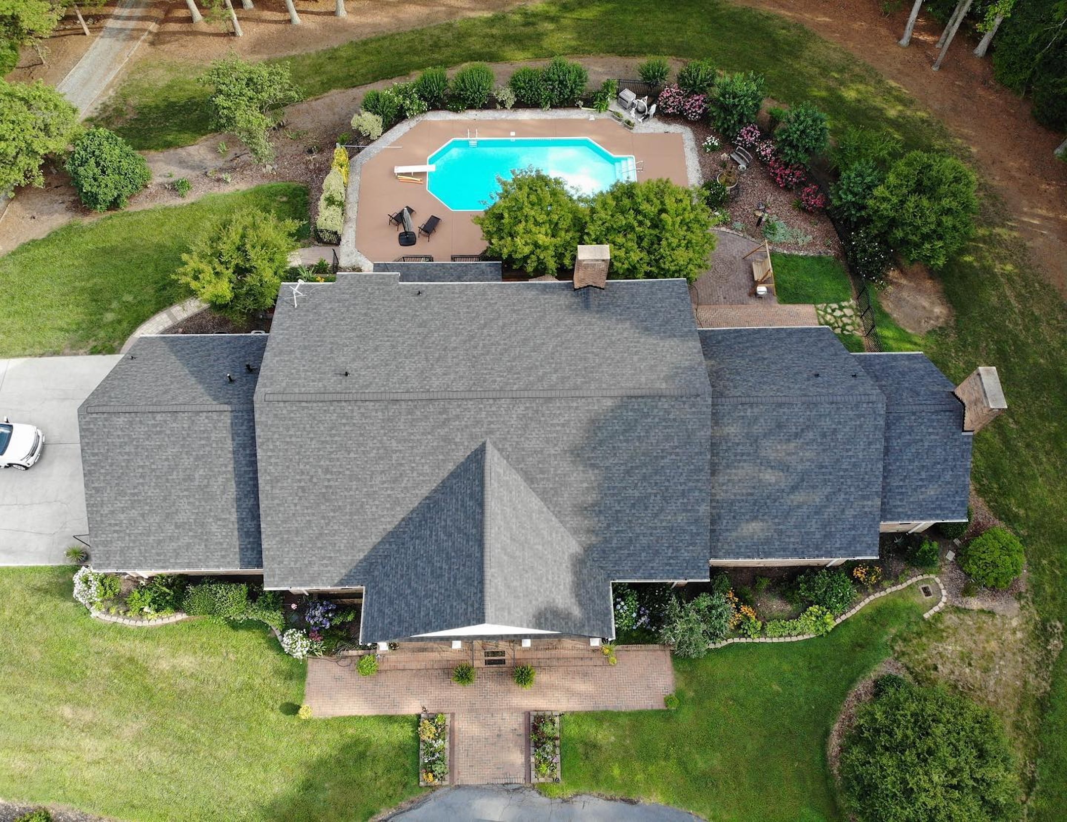 aerial view of black asphalt roofing with pool nc