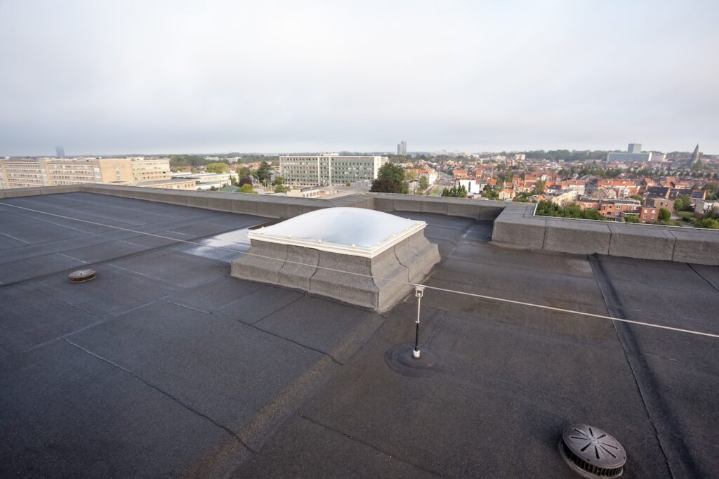 Plastic dome on a flat roof on a large building in the heart of the city