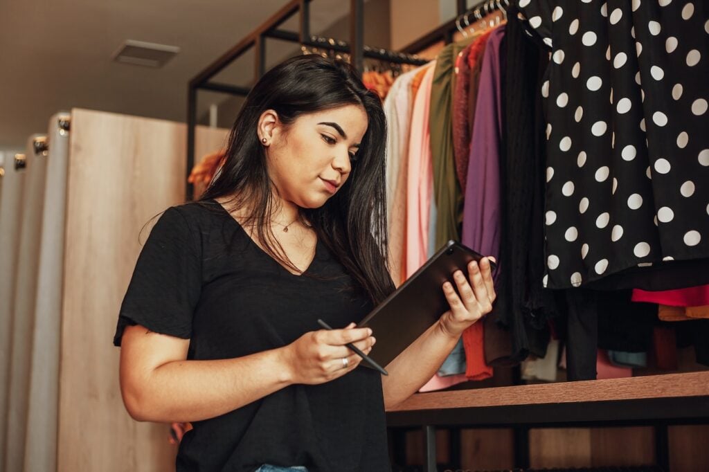 woman owner of small business. Entrepreneurial woman working in her clothing store.