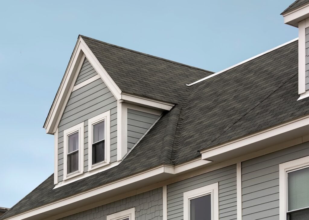 Detailed view of a gable-style dormer window on a sloped roof of a newly built family house i