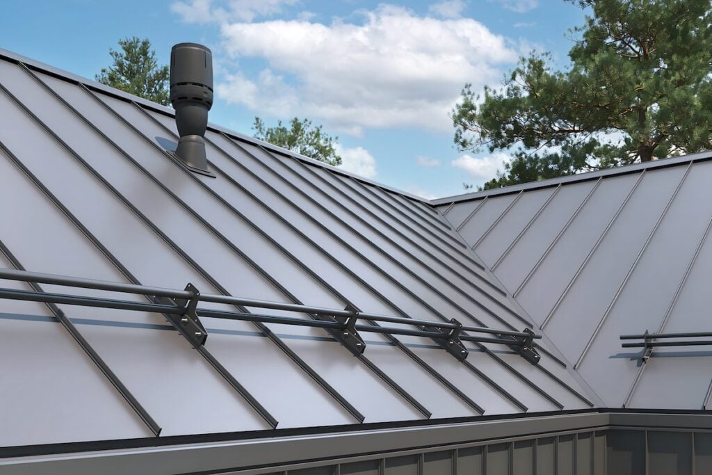Close-up house retro roof panel with standing seam and fasteners. Classic style black metal panel with rebate joint. Modern galvanized steel roofing sheet with ribs. Falz roofing. Building's covering