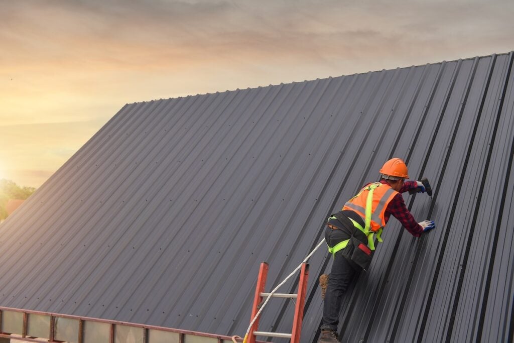 how to install metal roofing Roofer Construction worker install new roof,Roofing tools,Electric drill used on new roofs with Metal Sheet.