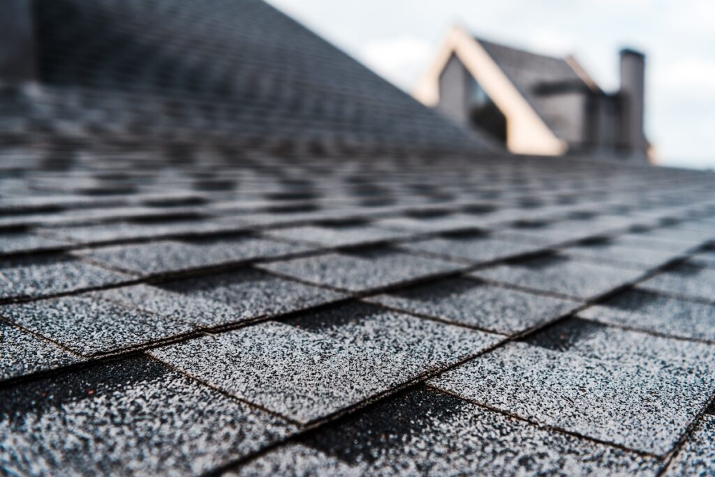 certainteed landmark shingles selective focus of grey shingles on rooftop of building