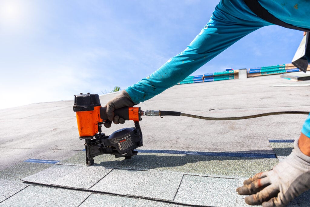 how to install roof shingles roofer installing roof shingles with roofing nailer.