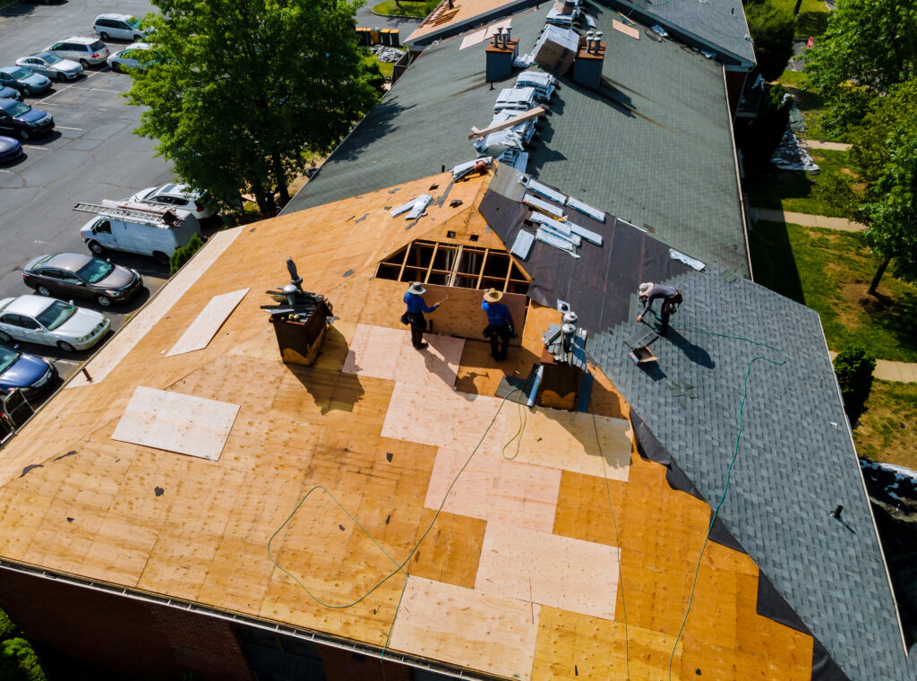 Construction worker on a renovation roof the house installed new shingles how to install roof shingles