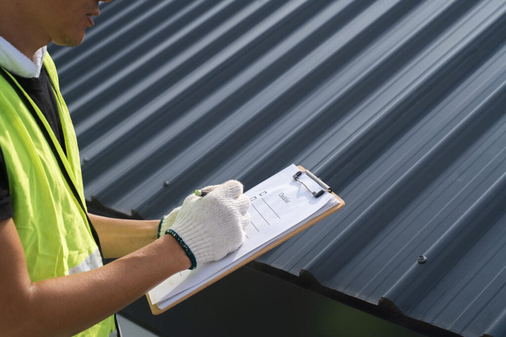 roof inspection cost Worker, inspector, engineer is check and inspect roof house or building quality after roofing repair replace with check list in hand. Inspect and checking concept