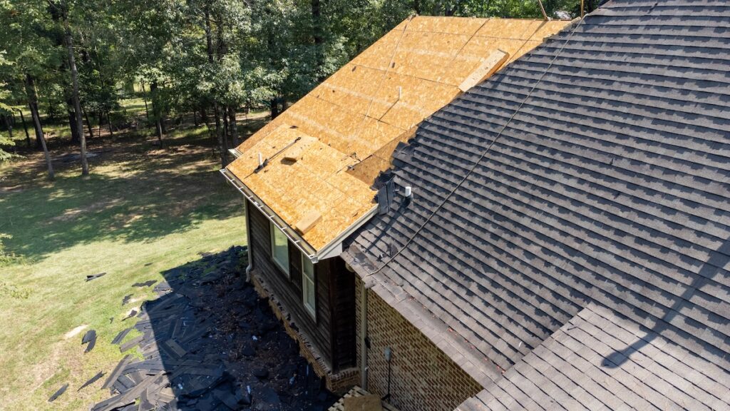 should i stay home during roof replacement House with new roof being installed after hail damage
