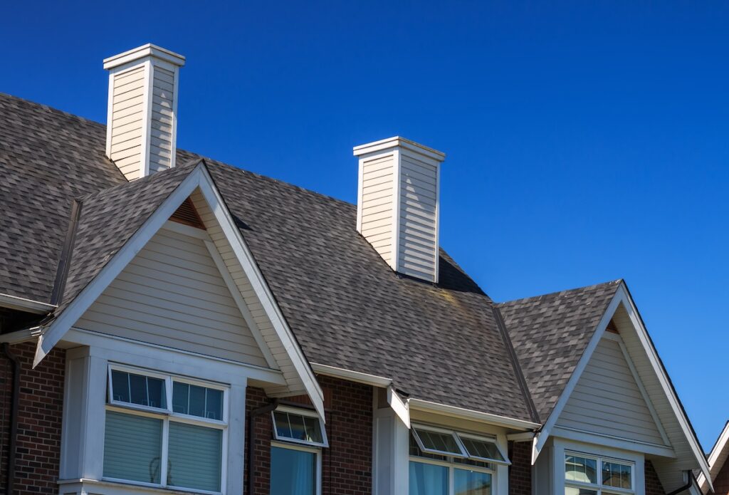 owens corning shingles Modern residential building against blue sky in North America.