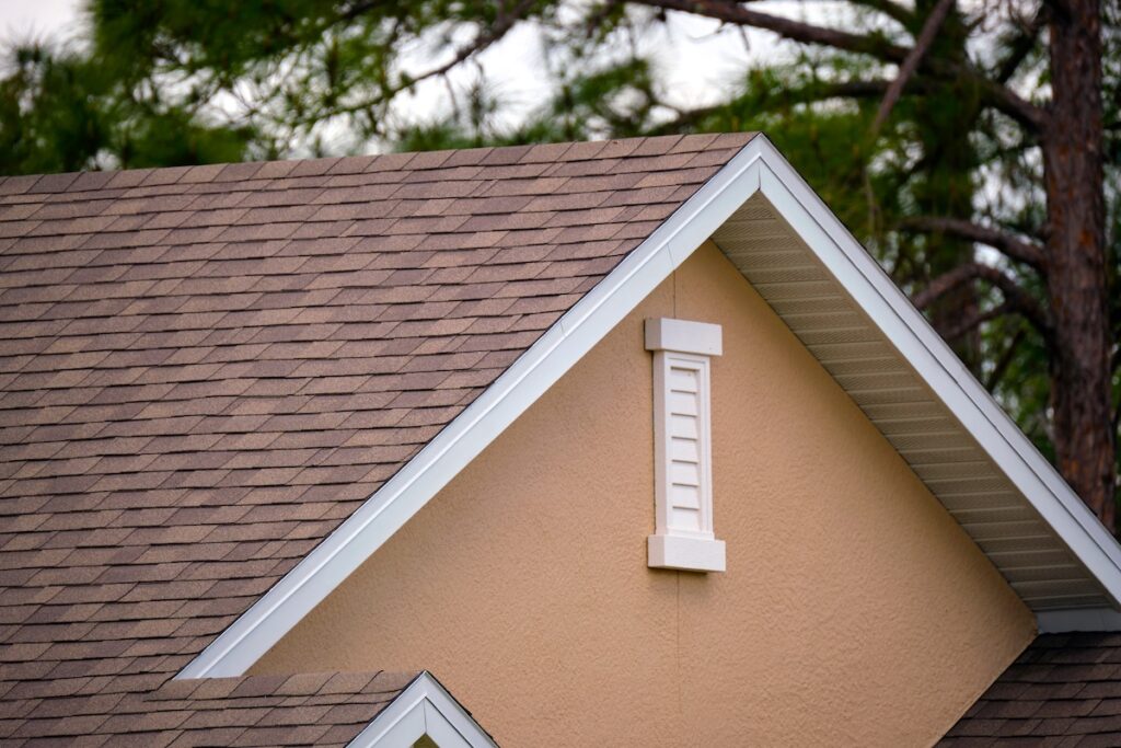 roofing protectionCloseup of house roof top covered with asphalt or bitumen shingles. Waterproofing of new building.