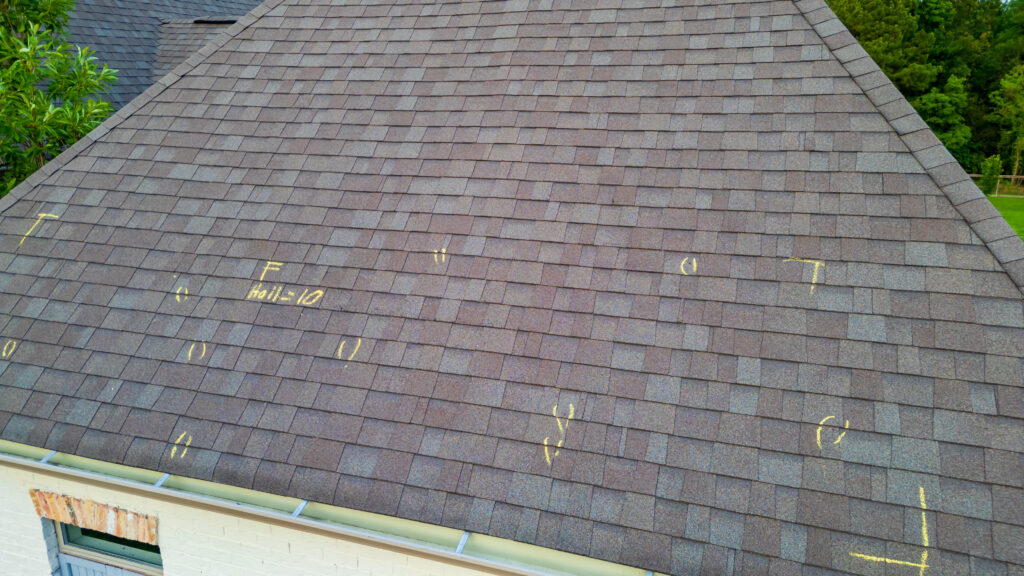 signs of hail damage on roof Roof with hail damage and marking from hail insurance inspection