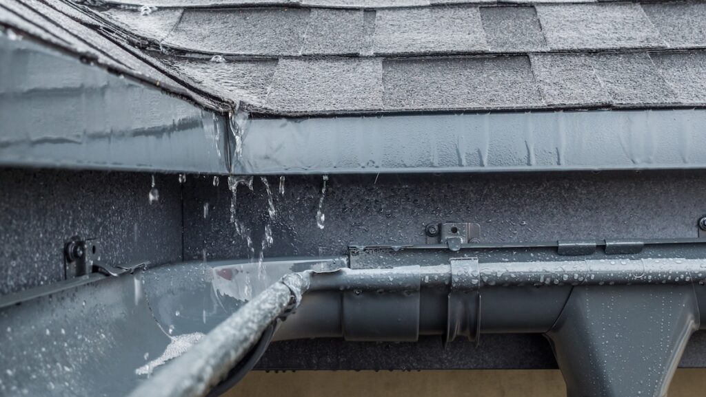 roof waterproofing Jets of rain drain into the drainage system on the roof of the house.
