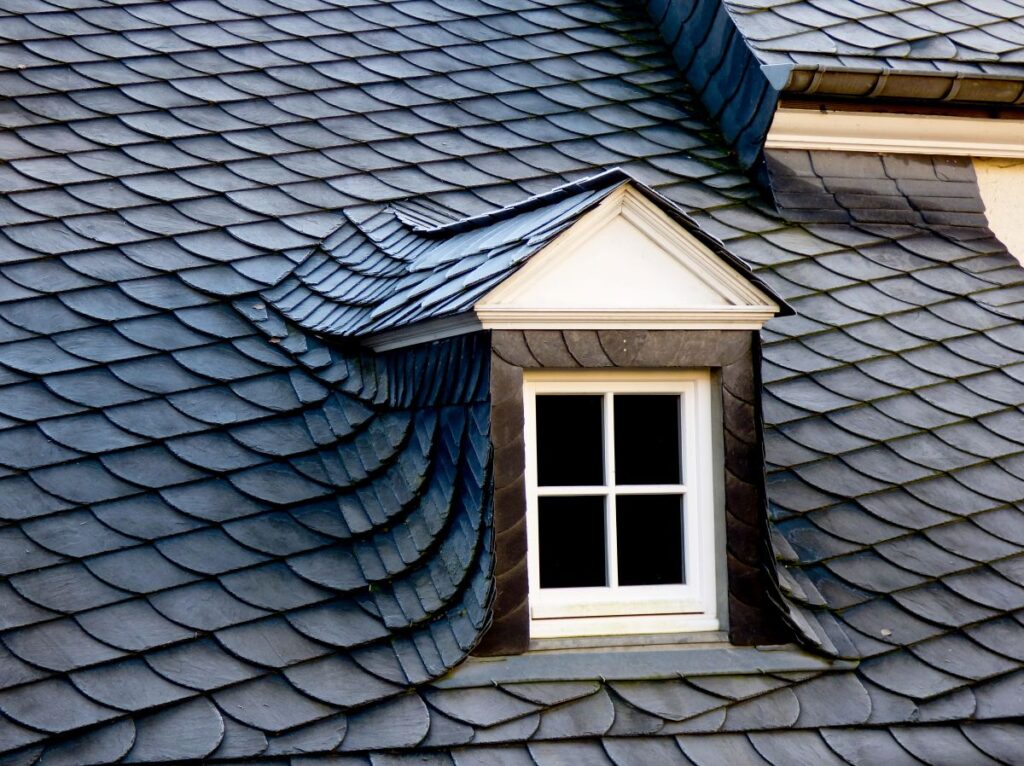 unique dark grey slate roof old white window
