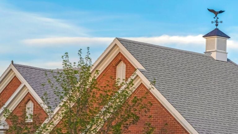 hip roof vs gable roof grey roof brick walls vent on top
