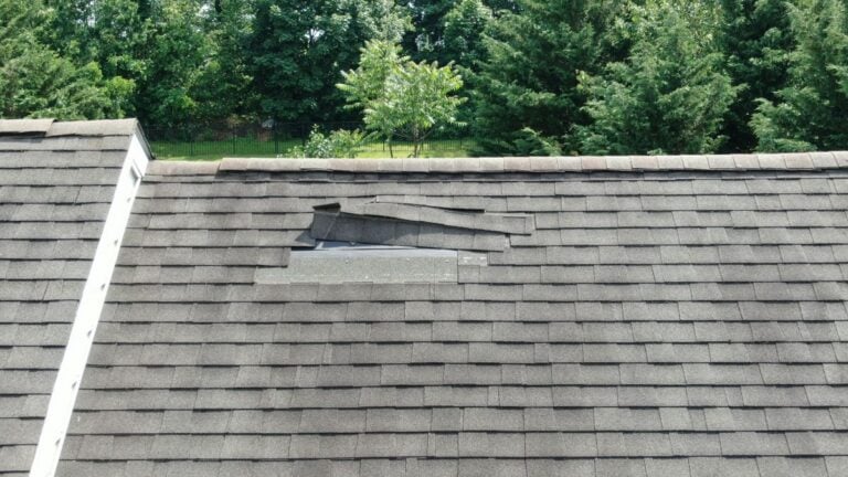 missing shingles falling after wind storm charcoal grey roof family house