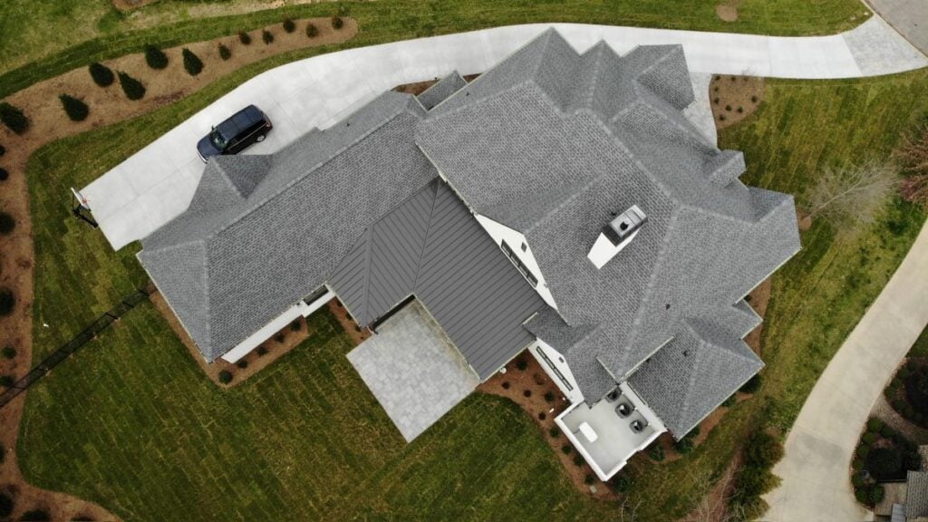 Aerial view of a roof with shingles and metal