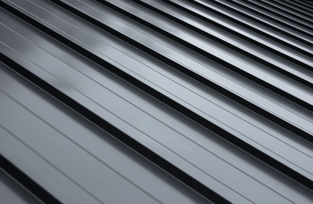 Modern galvanized steel roofing sheet with ribs. Classic style black metal panel with rebate joint.