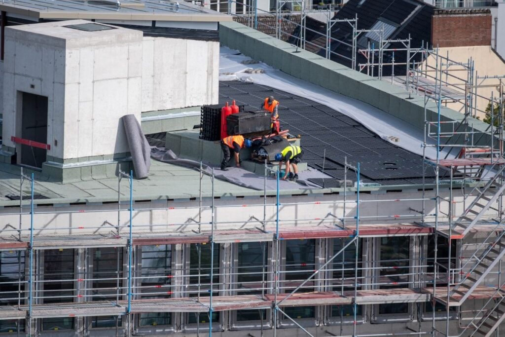 construction workers repairing a commercial roof
