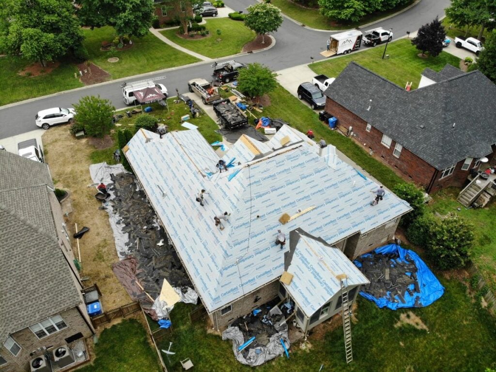 asphalt roofing contractor Great State Roofing project workers replacing shingles roof