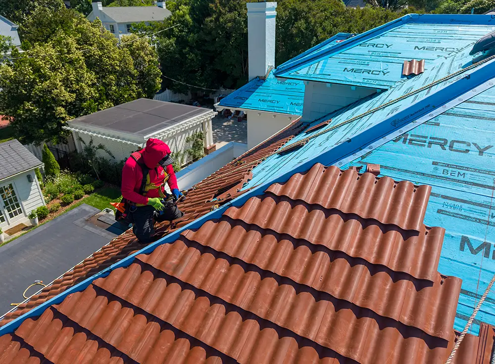 Custom copper valley installed with Brava barrel tile
