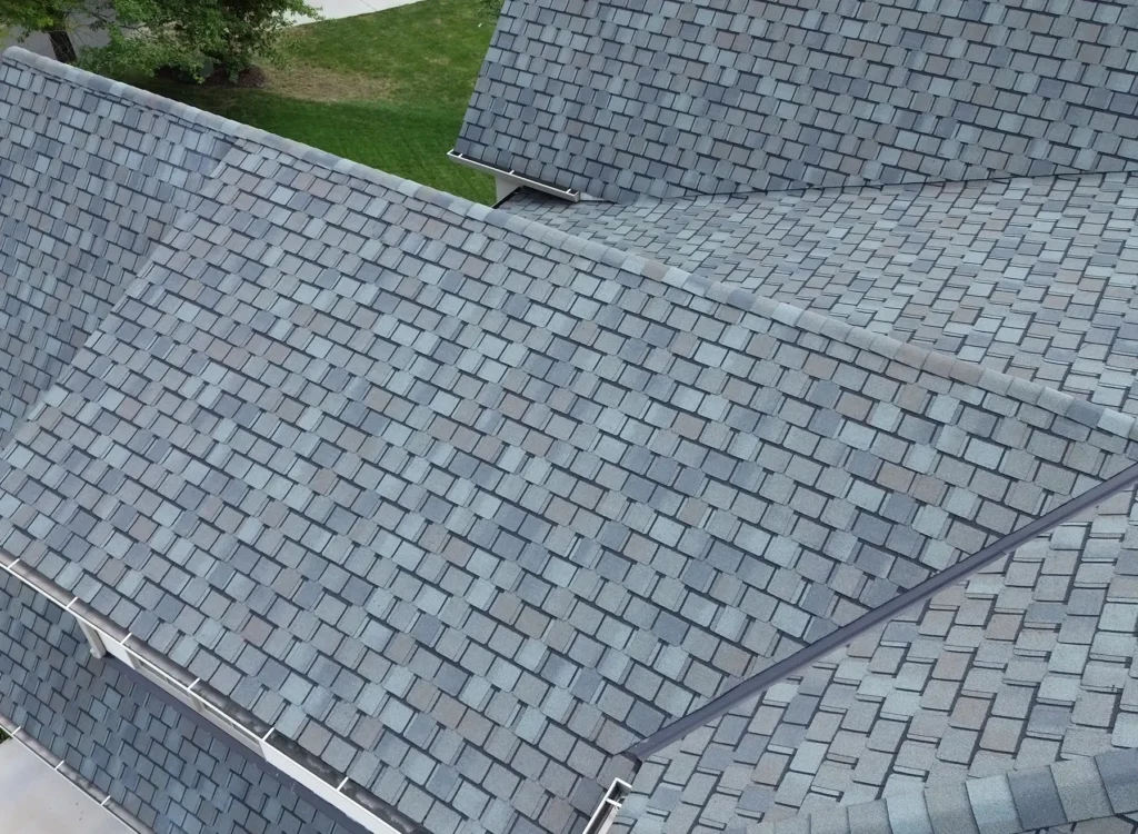 Aerial view of a house roof in Waxhaw NC featuring CertainTeed Belmont shingles, with intersecting rooflines and a green lawn in the background.